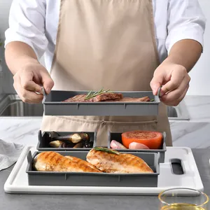 Set of 4 grey heat-resistant silicone baking trays held by a chef in a kitchen scene