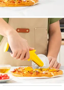 Detail showing the ergonomic yellow handle and stainless steel pizza cutting wheel.