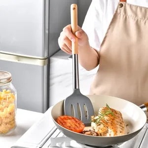 Heat resistant grey silicone slotted spatula with ergonomic wooden handle for non-stick pans