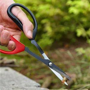 Ergonomic stainless steel garden pruning shears cutting a small branch in a lush garden