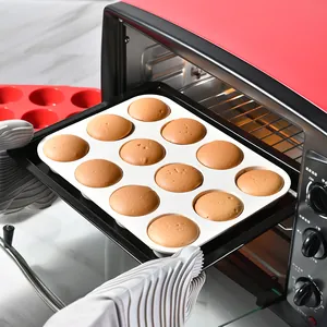 Twelve-hole white silicone muffin cake mold with freshly baked cupcakes in red oven