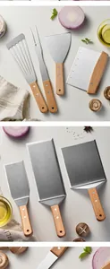 Detailed view of professional griddle spatulas and scrapers with wooden handles.