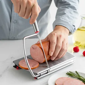 Professional stainless steel manual cheese and ham slicer with scale grid shown in use