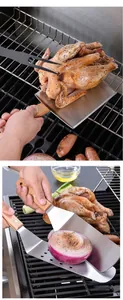 Close-up of wooden handle stainless steel griddle spatulas being used on a BBQ grill