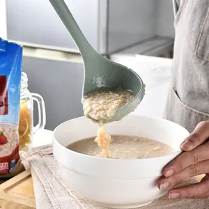Heat resistant food-grade silicone soup ladle scooping oatmeal porridge into a white bowl