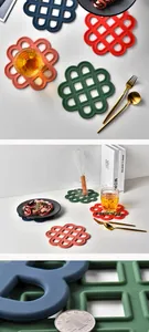 Macro view of colorful silicone heat resistant mats with hollow Chinese knot design