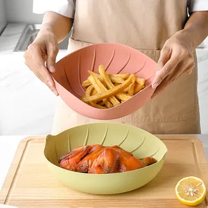Heat-resistant pink and green silicone air fryer liner pots with fries and roast chicken