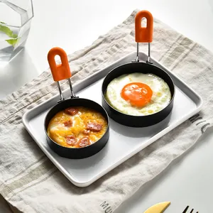 Set of two round non-stick egg rings with orange heat-resistant silicone handles