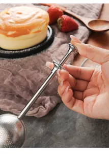 Stainless steel push-style tea infuser and flour duster shown being operated by hand.