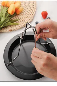 Detail showing hands installing the stainless steel wire rack onto the black roasting pan
