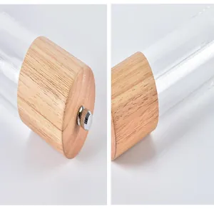 Close-up view of the acrylic pepper mill featuring an oak base and adjustable metal knob