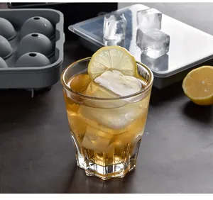 Macro detail of large square ice cubes in a drink with gray silicone mold set