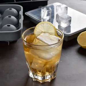 Large silicone ice cube trays with lids featuring square and sphere molds for drinks