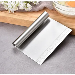 Detailed view of stainless steel dough scraper with integrated 15cm measurement scale.