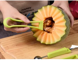 3-piece fruit carving and melon baller set with green handles on a wooden board