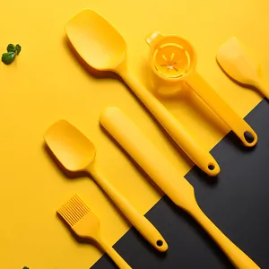 Professional yellow silicone baking tool set including spatulas and pastry brush