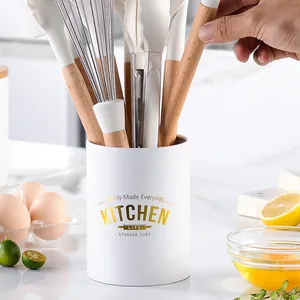 Elegant white kitchen utensil storage tube featuring silicone tools with wooden handles