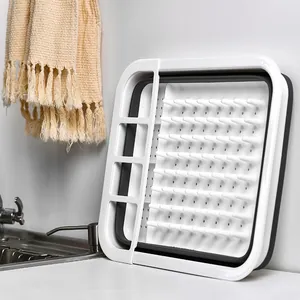 Collapsible white and grey dish drying rack for kitchen sink storage organization
