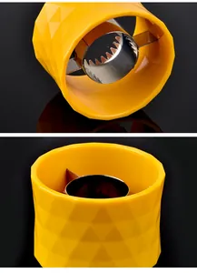 Close-up detail of the inner stainless steel serrated blades and yellow plastic body.
