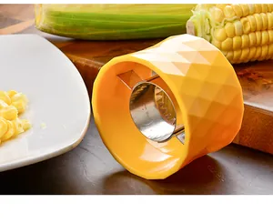 Yellow circular corn stripper with stainless steel blade shown in a kitchen setting