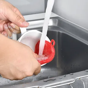 Red circular silicone dishwashing brush for efficient multipurpose kitchen cleaning