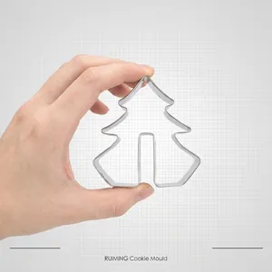 Stainless steel 3D Christmas tree cookie cutter shown held by hand for sturdiness