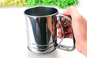 Handheld stainless steel flour sifter cup featuring a manual trigger mechanism for baking