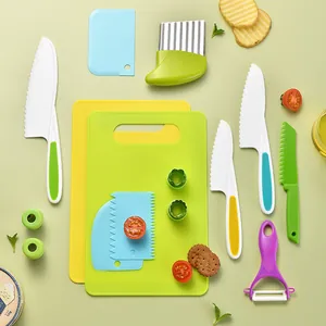 Colorful plastic kitchen tool set for kids including knives, peelers and cutting boards
