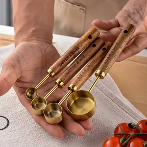 Gold stainless steel measuring spoon set with acacia wood handles for baking