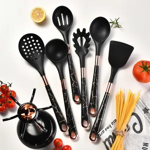 Complete 7-piece black silicone kitchen utensil set with rose gold accents and rotating stand