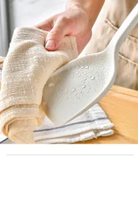Close-up of heat-resistant silicone spatula with water droplets showing non-stick surface