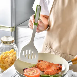 Heat-resistant silicone slotted spatula for non-stick pans in a kitchen setting