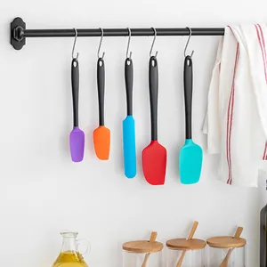 5-piece colorful silicone spatula set hanging on kitchen rack for baking and cooking.