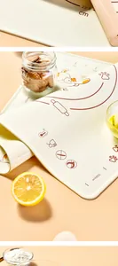 Close-up of silicone kneading mat with orange cat design and metric measurements