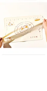 Close-up of flexible silicone kneading mat with cute orange cat and measurement scales