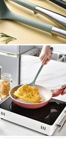 Action shot of heat-resistant silicone spatula flipping an omelet in a non-stick pan