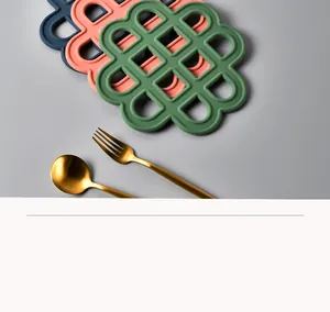 Macro detail of heat-resistant silicone trivets in blue, pink, and green colors