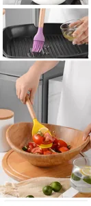 Professional detailed view of silicone brush and spatula being used in a kitchen setting