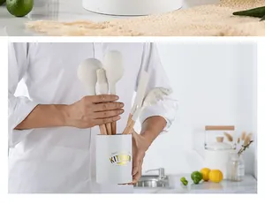 White kitchen tool storage holder with wooden handle silicone utensils in a kitchen setting