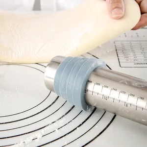 Stainless steel adjustable rolling pin with scale markings and thickness rings for dough.