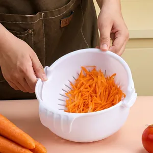 White multifunctional vegetable slicer and colander used for draining shredded carrots.