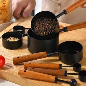 8-piece black stainless steel measuring cup and spoon set with wooden handles