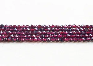 Close-up view of faceted natural red garnet beads for DIY jewelry making accessories