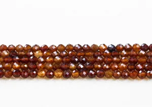 Macro detail view of natural faceted orange garnet round beads for DIY jewelry making