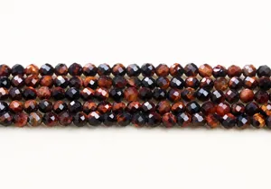 Detailed view of faceted red tiger eye round beads showing rich reddish-brown texture
