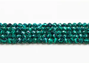 Close-up of green faceted synthetic malachite round beads for DIY jewelry making