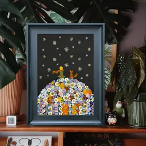 Vue détaillée d'un cadre photo 3D profond avec l'art des fleurs séchées du Petit Prince.