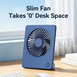 Portable slim blue desktop USB fan placed on a sunny wooden office desk by a window