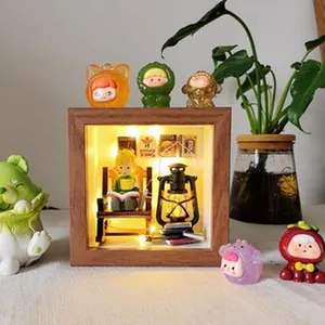 Détail d'un cadre vitrine 3D en noyer présentant une scène miniature chaleureuse avec LED