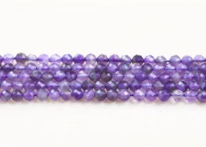 Close-up macro view of natural purple faceted amethyst round beads for DIY jewelry making